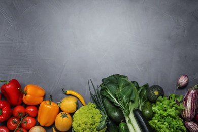Photo of Flat lay composition with fresh vegetables and space for text on grey background