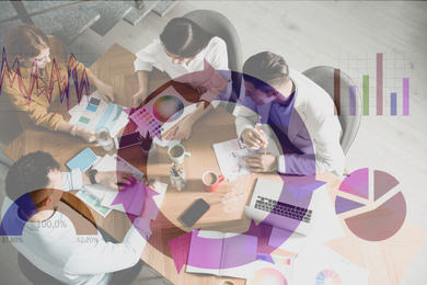 Image of Team of professional designers working together at table and colorful graphs illustration. Double exposure