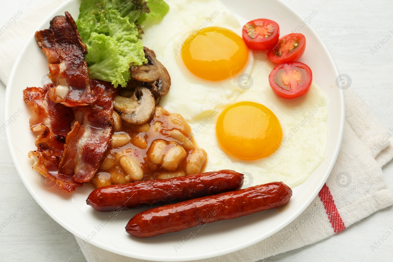 Photo of Delicious breakfast with sunny side up eggs on white table, closeup