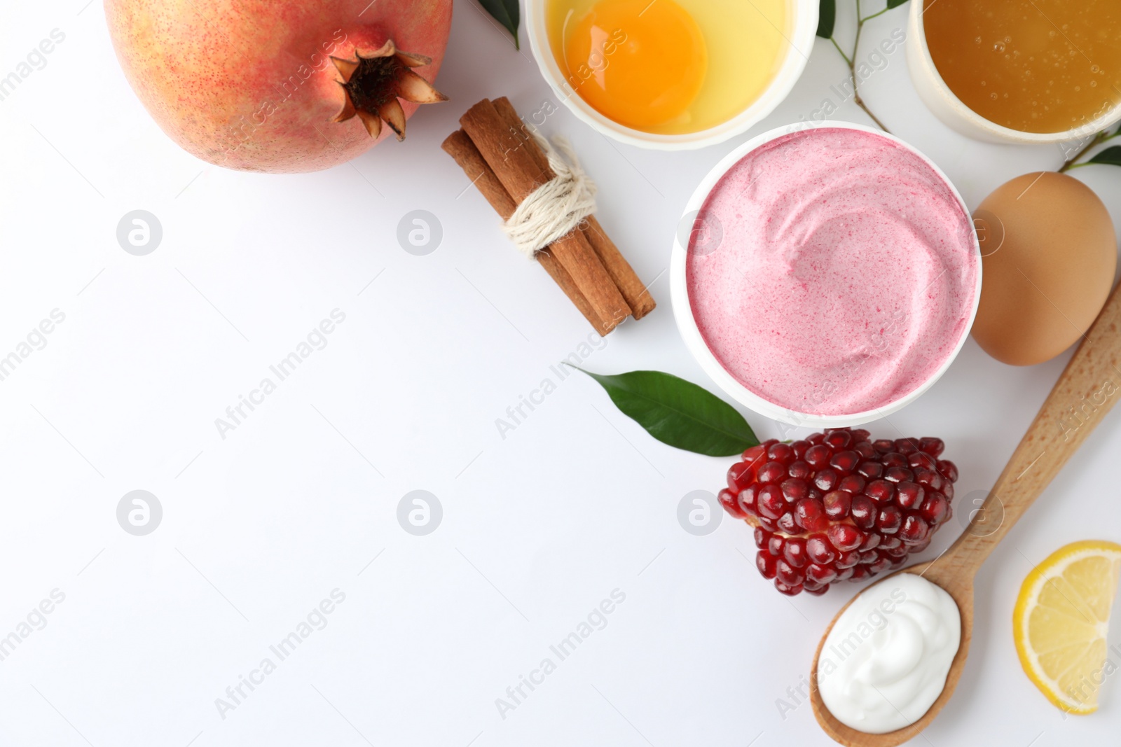 Photo of Composition with natural homemade mask, pomegranate and ingredients on white background, top view