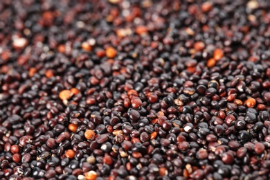 Raw black quinoa seeds as background, closeup