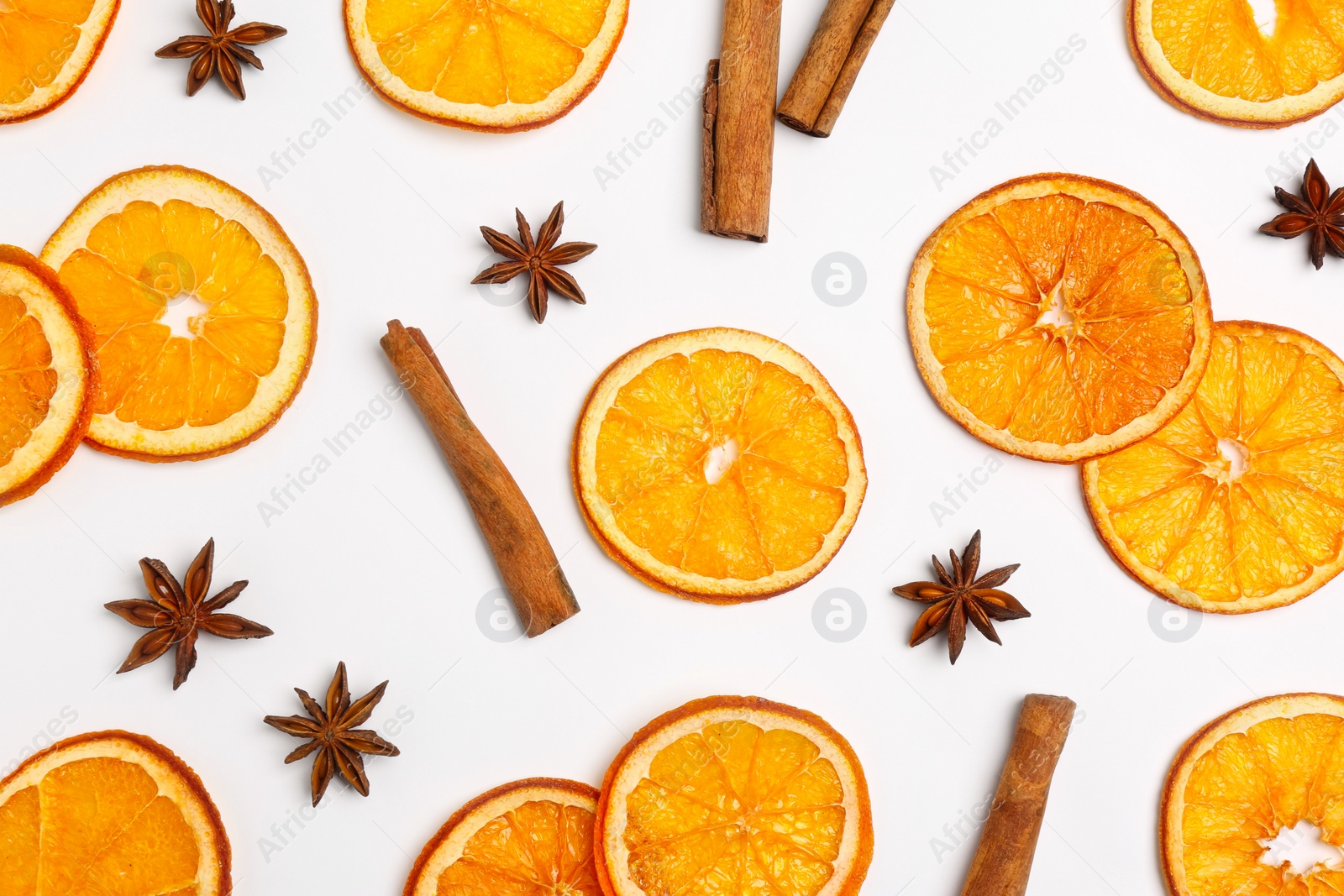 Photo of Flat lay composition with dry orange slices, anise stars and cinnamon sticks on white background