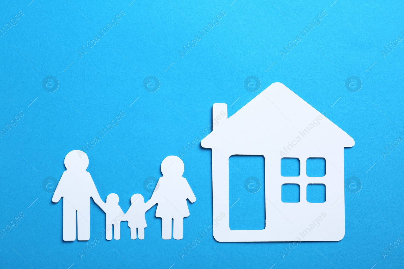 Photo of Paper silhouettes of family and house on color background, flat lay. Life insurance concept