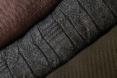 Closeup view of different warm folded sweaters as background