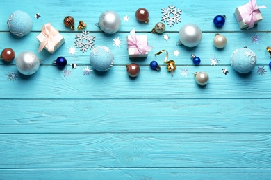 Flat lay composition with Christmas decorations on blue wooden background, space for text. Winter season