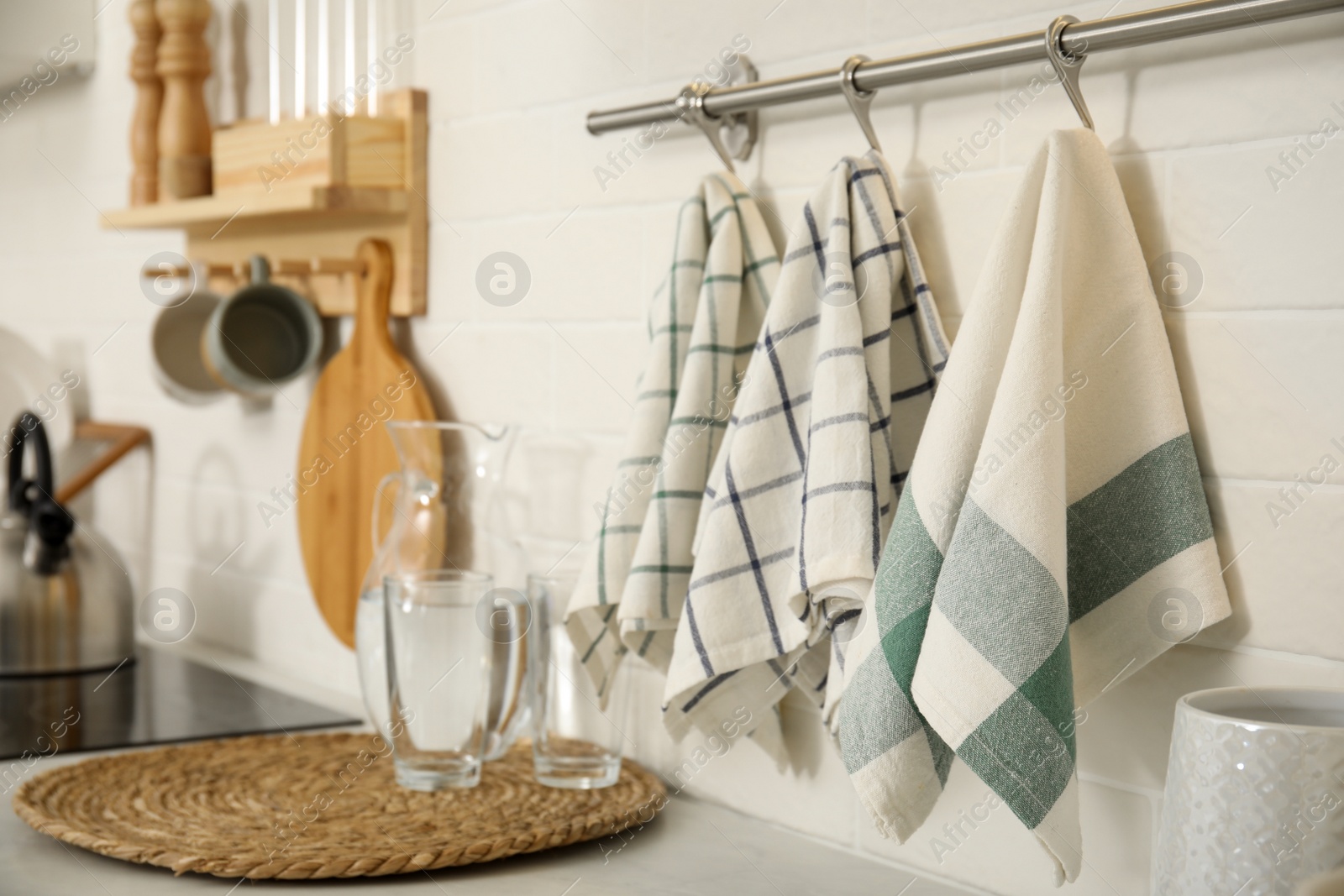 Photo of Different clean towels hanging on rack in kitchen