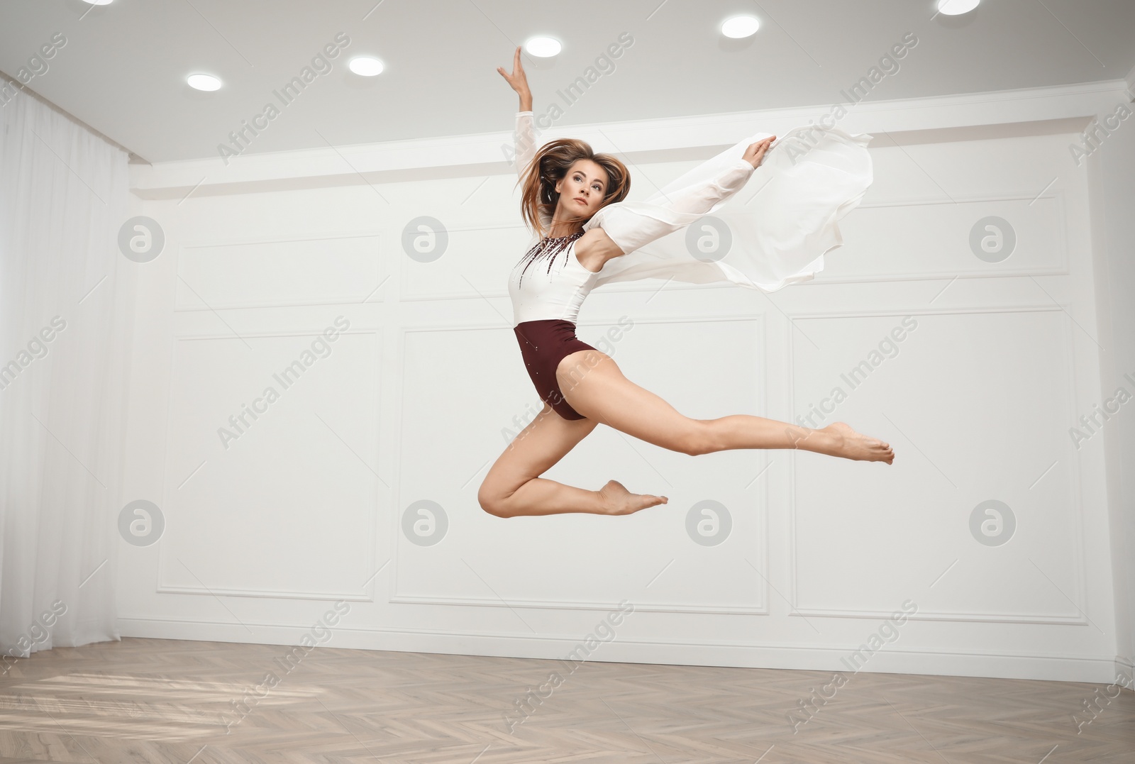 Photo of Beautiful professional dancer practicing moves in studio