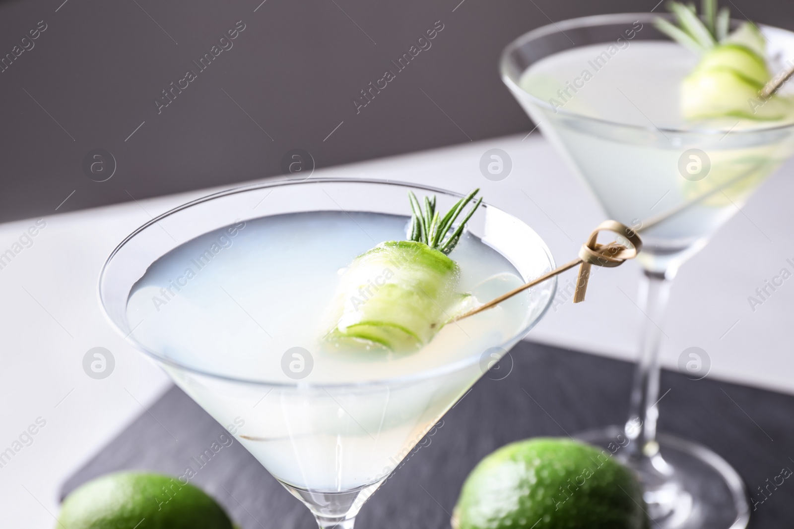 Photo of Glasses of cucumber martini on table against dark background, closeup. Space for text