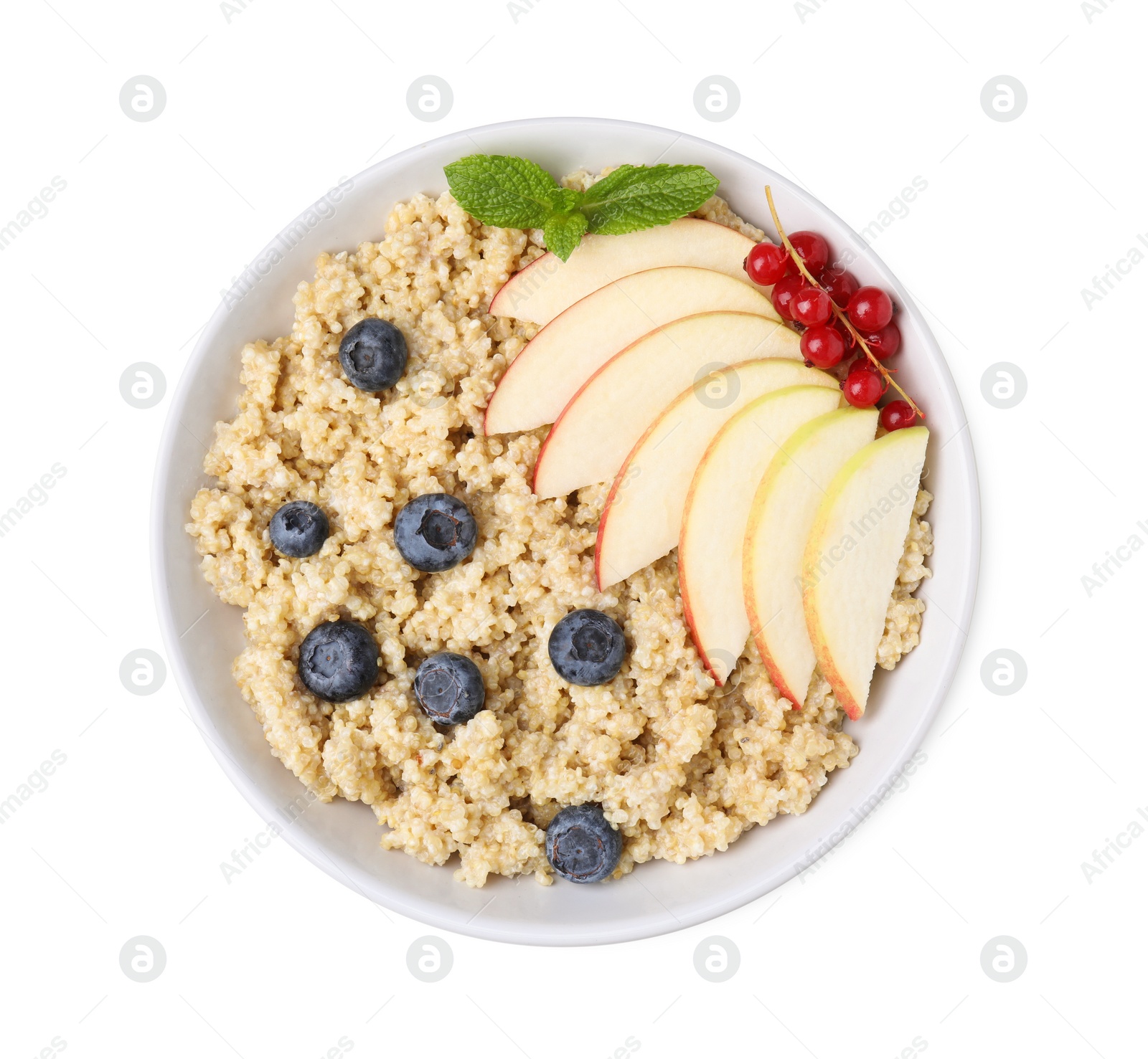 Photo of Bowl of delicious cooked quinoa with apples, blueberries and cranberries isolated on white, top view