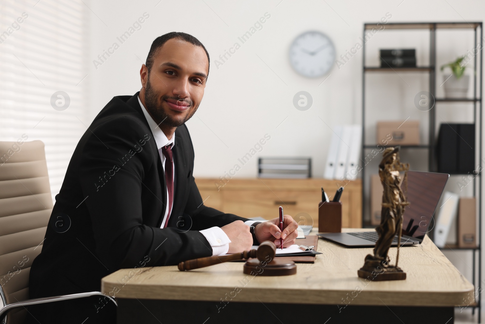 Photo of Portrait of successful lawyer at table in office