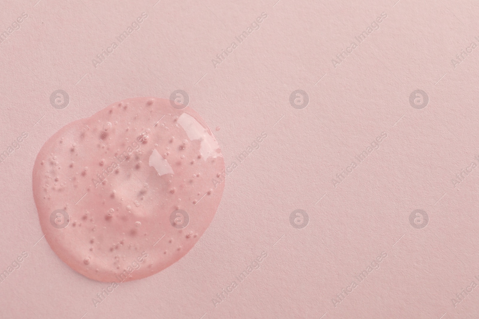 Photo of Sample of face gel on pink background, top view. Space for text