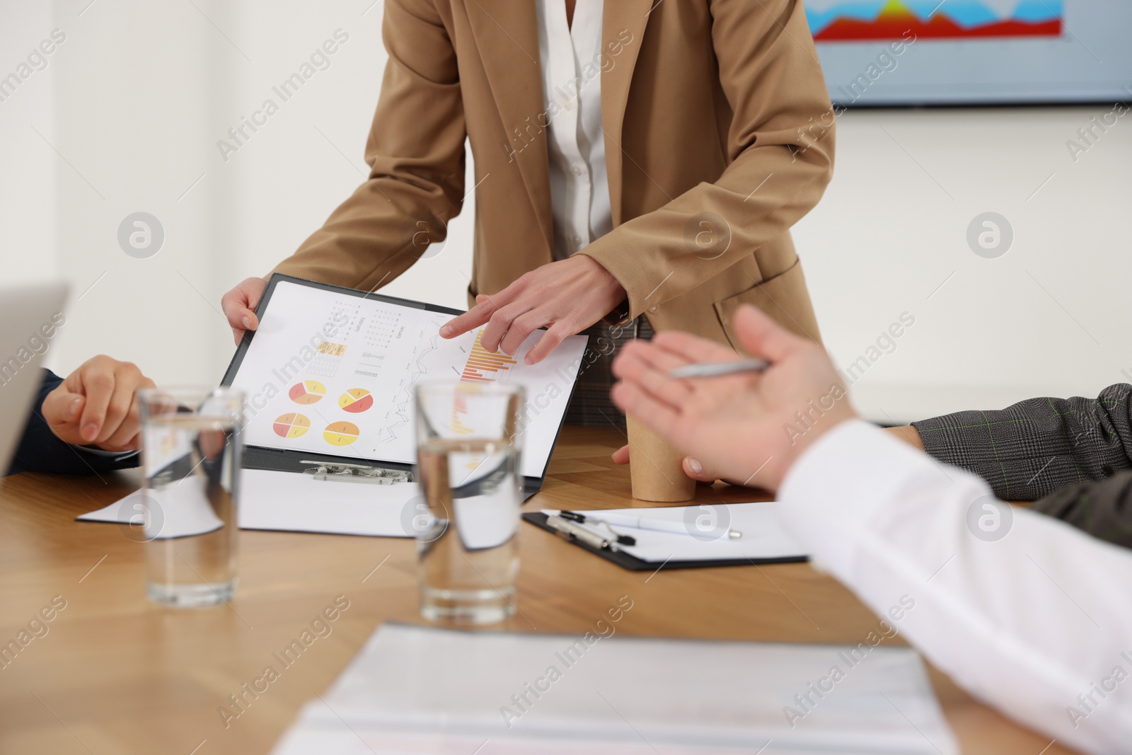 Photo of Businesswoman showing chart on meeting in office, closeup