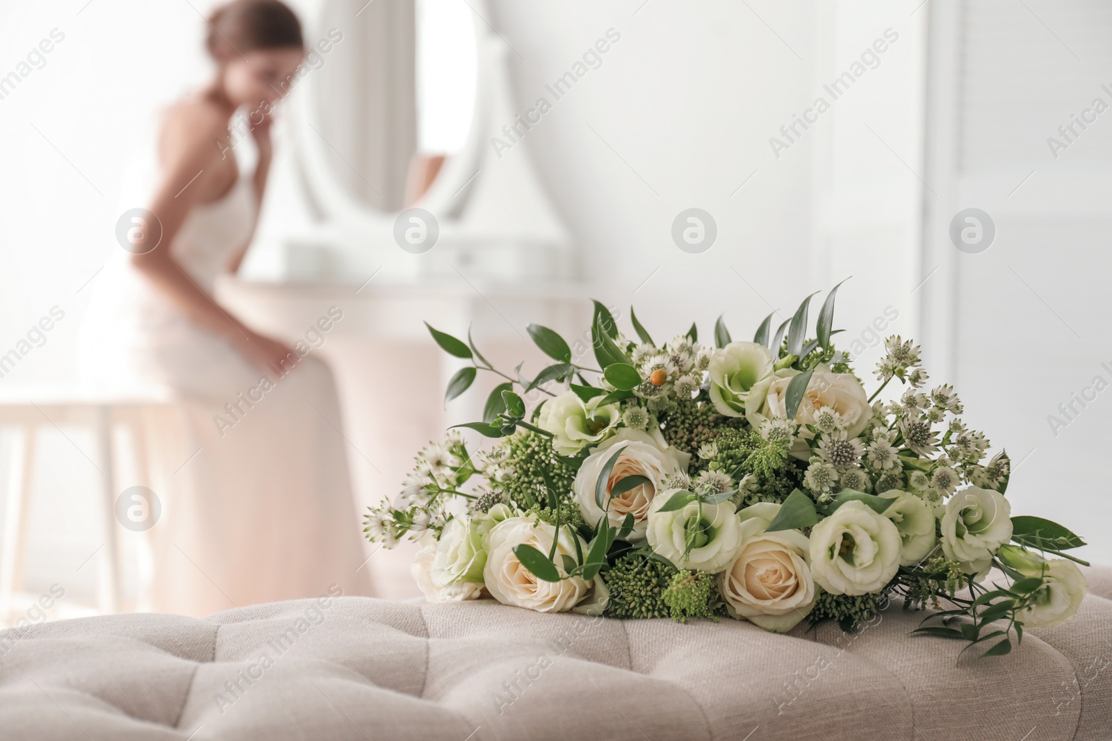 Photo of Beautiful wedding bouquet on bench in room