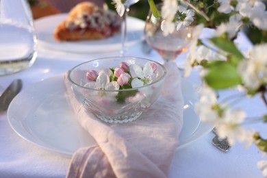 Photo of Stylish table setting with beautiful spring flowers in garden