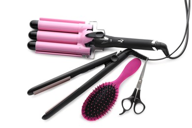 Different professional hairdresser tools on white background, top view