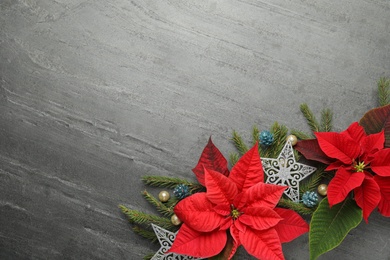 Flat lay composition with beautiful poinsettia on grey background, space for text. Christmas traditional flower