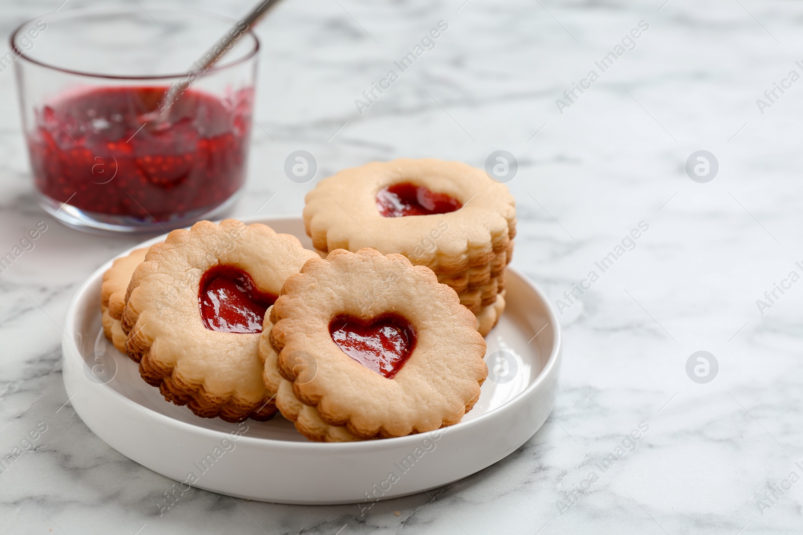 Photo of Traditional Christmas Linzer cookies with sweet jam on plate