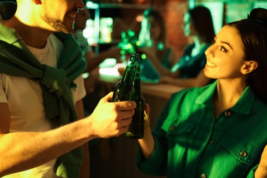 Photo of Couple with beer celebrating St Patrick's day in pub