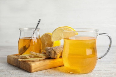 Photo of Composition with cold remedies on white wooden table. Sore throat treatment