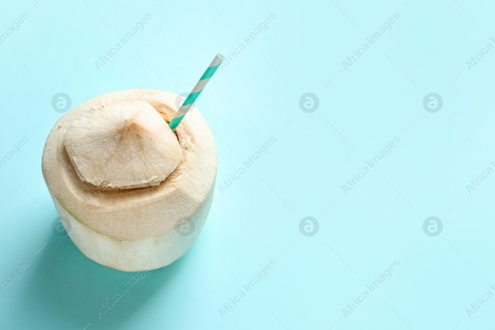 Photo of Fresh coconut drink in nut on color background