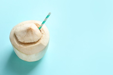 Photo of Fresh coconut drink in nut on color background