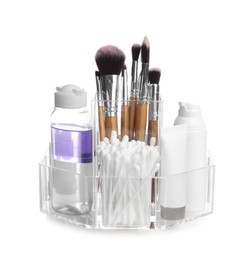 Cosmetic products in organizer on white background