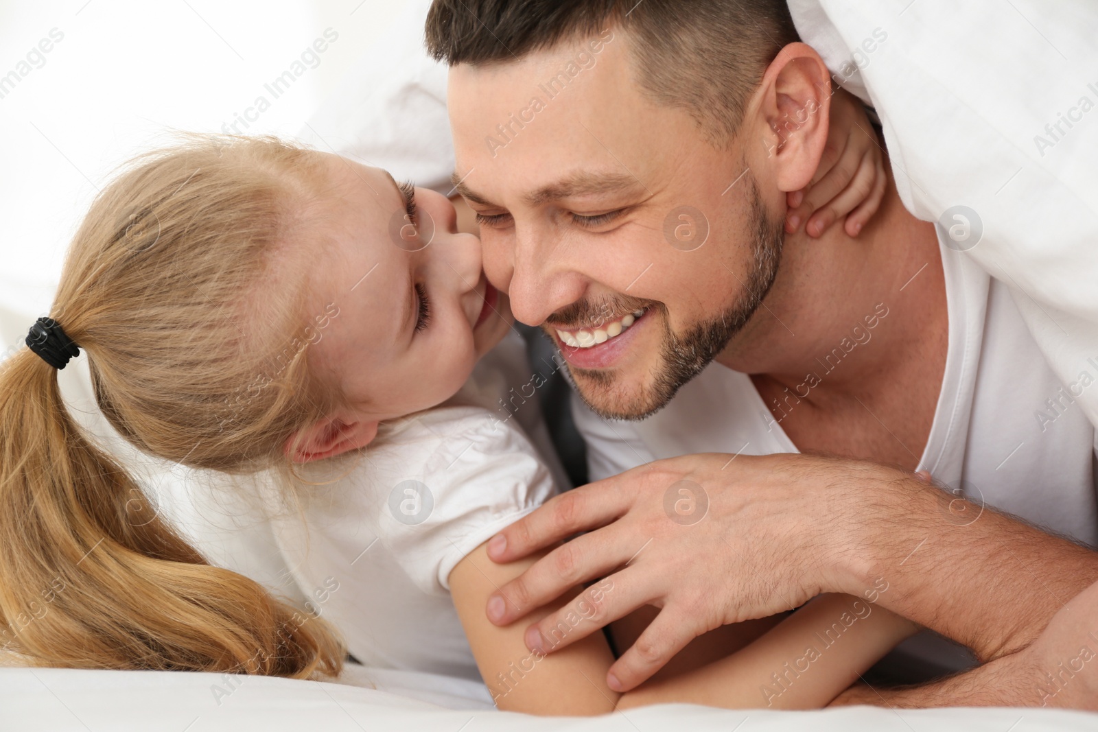 Photo of Dad and daughter spending time together at home. Happy Father's Day