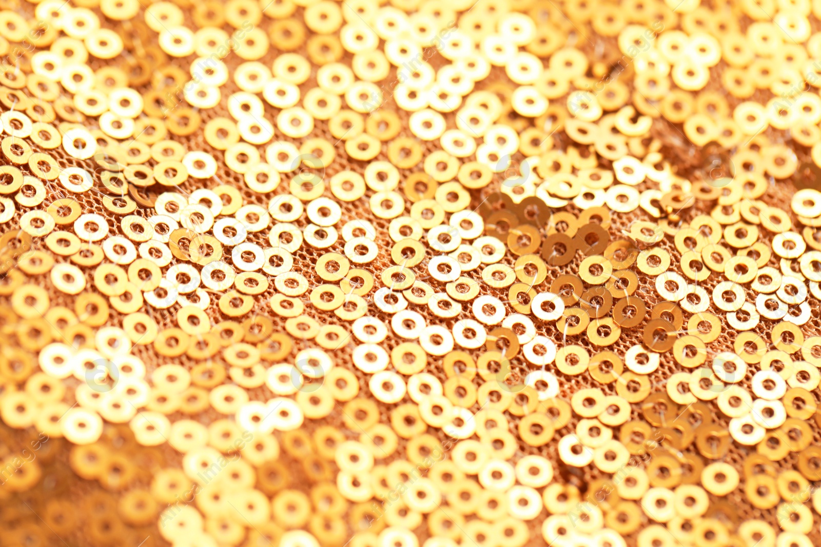 Photo of Beautiful golden shiny cloth with sequins as background, closeup