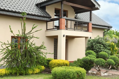 Picturesque view of beautiful house and garden on sunny day