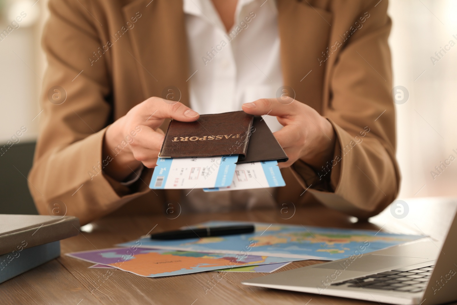 Photo of Travel agent with tickets and passports in office, closeup