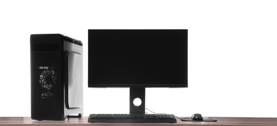 Photo of Modern computer with blank monitor screen and peripherals on wooden table against white background