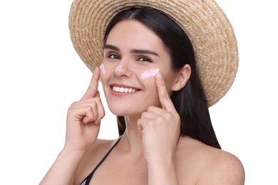 Beautiful young woman with sun protection cream on her face against white background