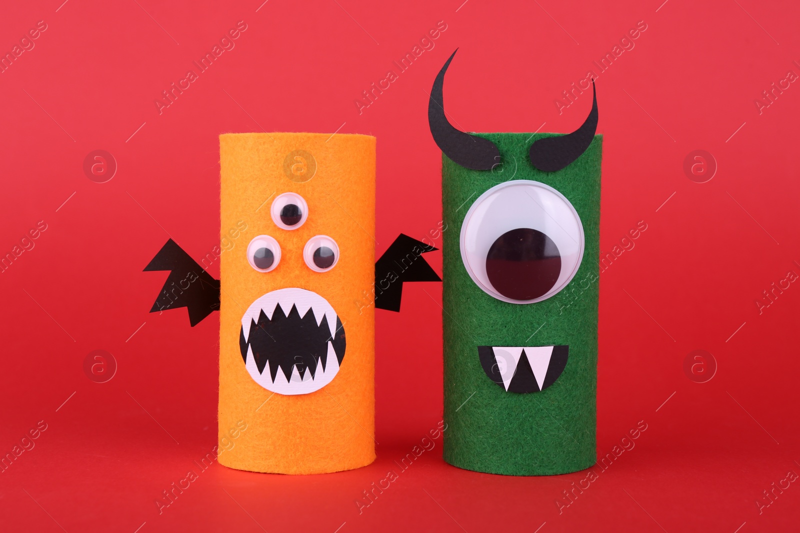 Photo of Spooky monsters on red background. Handmade Halloween decoration