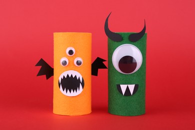 Photo of Spooky monsters on red background. Handmade Halloween decoration