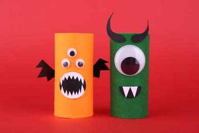 Spooky monsters on red background. Handmade Halloween decoration