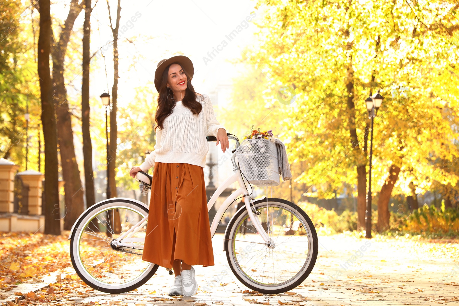 Photo of Beautiful happy woman with bicycle in autumn park