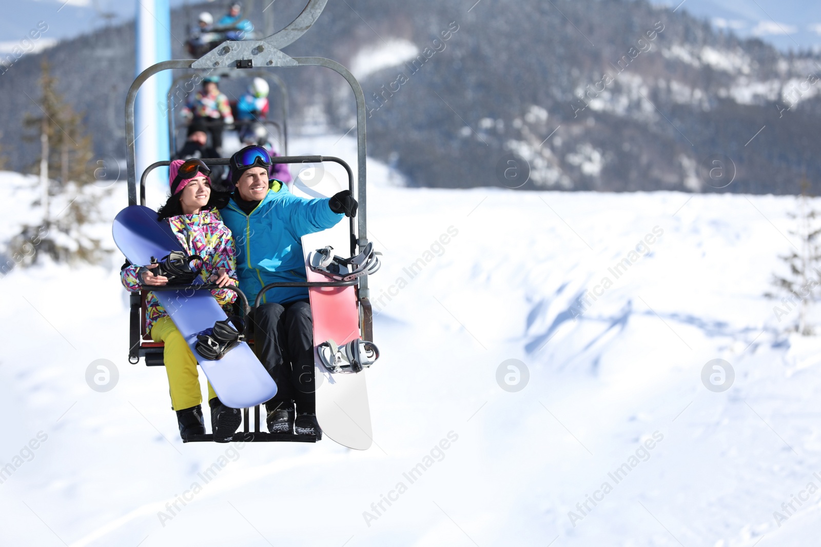 Photo of People using chairlift at mountain ski resort, space for text. Winter vacation