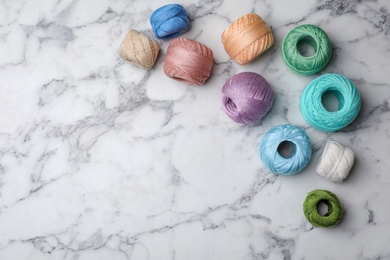 Photo of Flat lay composition with color threads on marble background