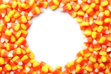 Photo of Colorful candy corns for Halloween party on white background, top view
