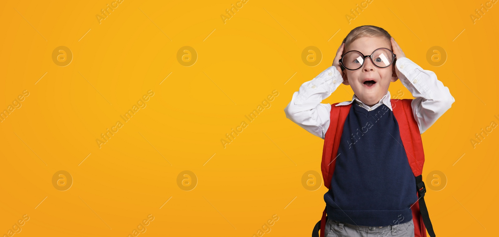 Image of First time at school. Funny little child wearing glasses on yellow background, space for text. Banner design