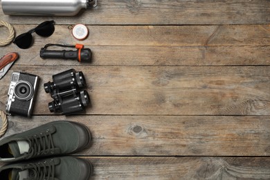 Photo of Flat lay composition with different safari accessories on wooden background, space for text