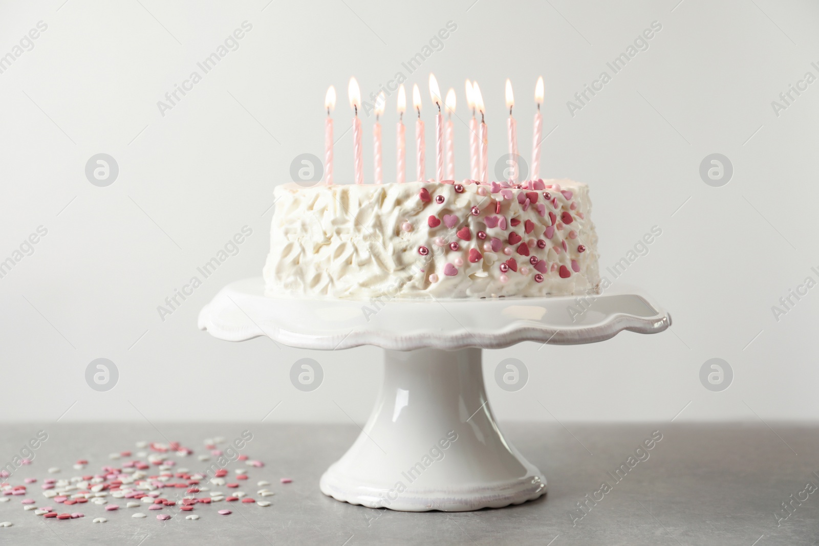 Photo of Birthday cake with candles on table against light background