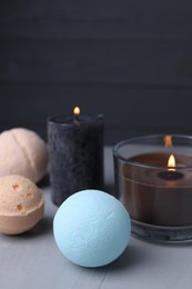 Photo of Beautiful composition with aromatic bath bombs on light grey table, closeup. Space for text