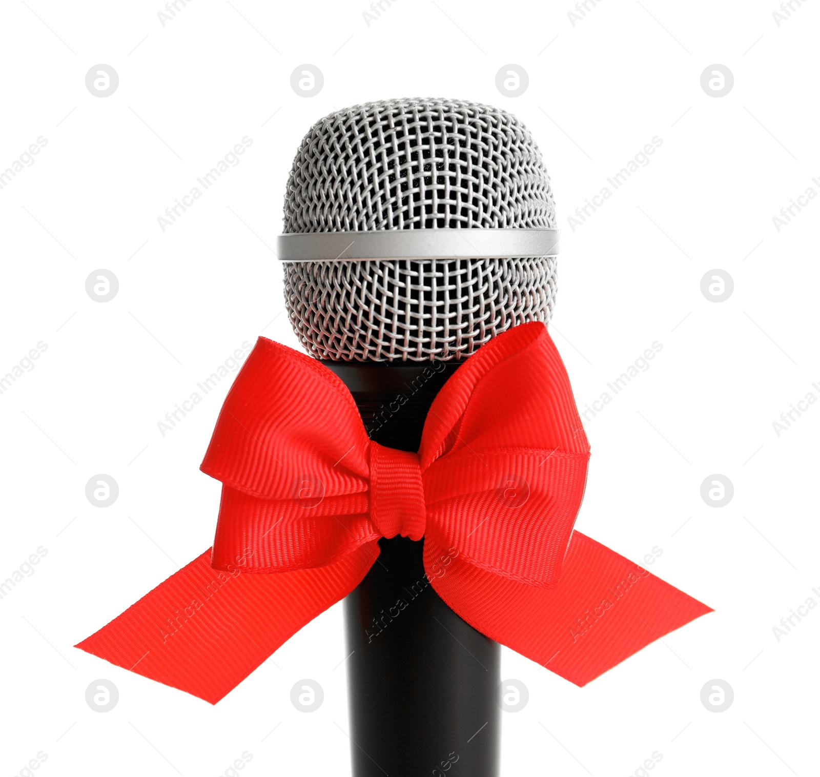 Photo of Microphone with bow on white background. Christmas music concept