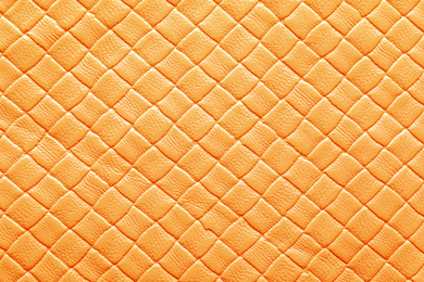 Texture of orange leather as background, closeup