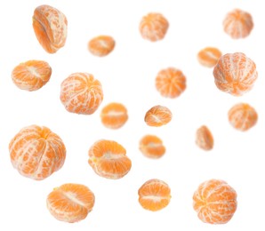 Fresh ripe tangerines falling on white background