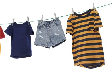 Photo of Different clothes drying on washing line against white background