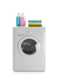 Modern washing machine, stack of towels and detergents on white background. Laundry day