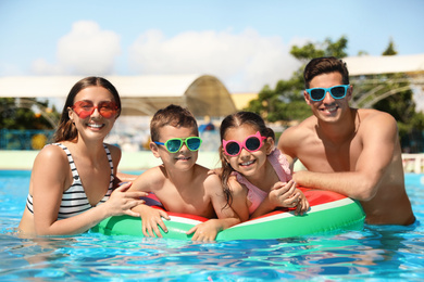 Photo of Happy family in swimming pool. Summer vacation