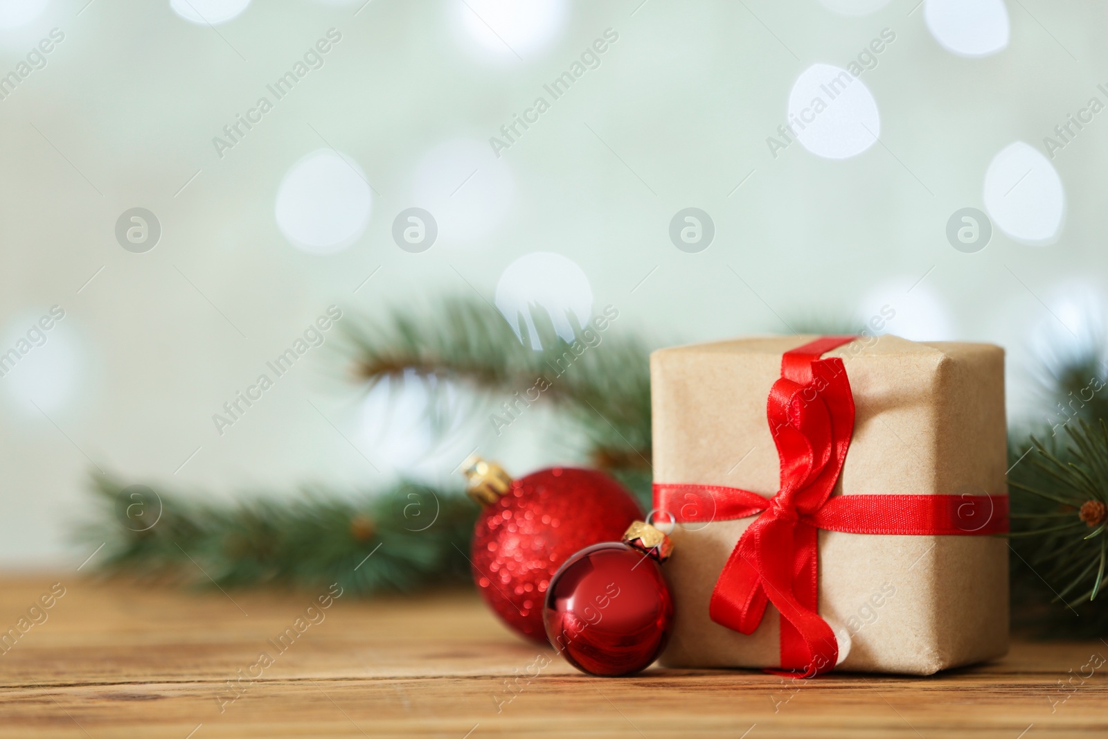 Photo of Christmas decorations on table against blurred background, space for text. Bokeh effect